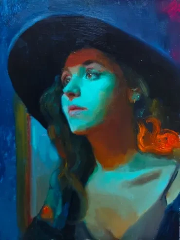 Portrait of a woman in a black hat with dramatic lighting