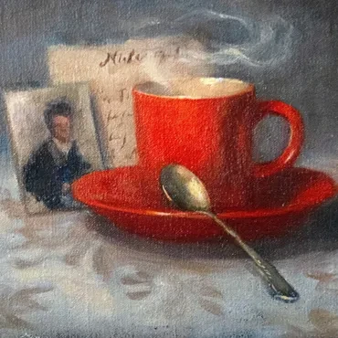 Still life of a red cup and saucer with vintage photographs
